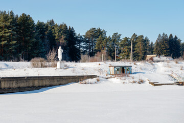 Genre sculpture Komsomol girl (1937) installed on the barrier gate No. 103 of the Moscow channel, the village of Orevo, Dmitrovsky district of the Moscow region, Russia