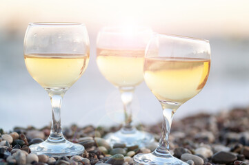 Reflection of two glasses of white wine on tropical beach