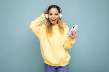 Photo shot of beautiful joyful smiling young female person wearing stylish casual outfit isolated...