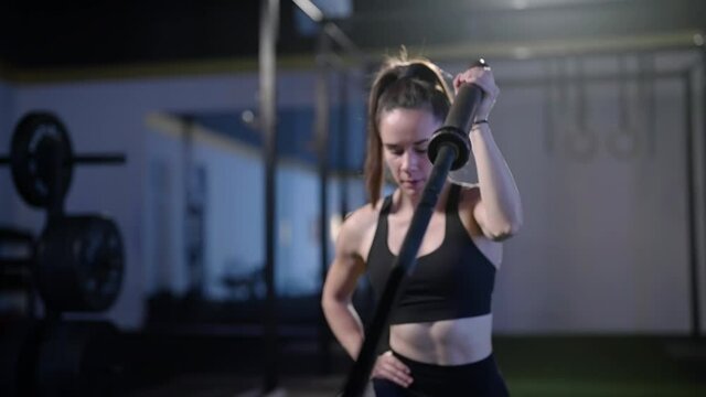 Fitness woman exercise landmine press with barbell while kneel weightlifting 4K
