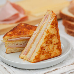 Traditional homemade Monte Cristo sandwich with ham and cheese on a white background. Breakfast, brunch. Selective focus