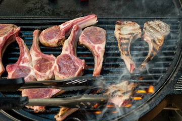 Lamb cutlets chops grilling on barbecue plate . Backyard BBQ grill cooking. Australia Day...