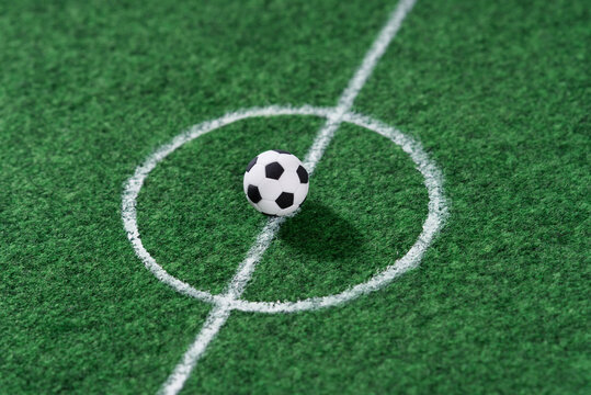 Black and white soccer ball in the center of the soccer field, decoration mini football.