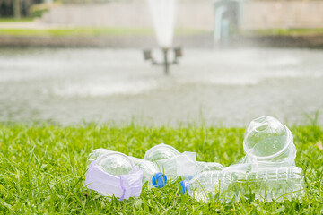 Lots of plastic water bottles on the ground were dumped in the park.