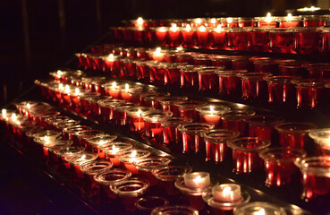 Rows of lighted candles in a church during a Christmas service