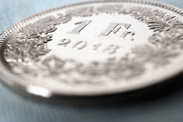 1 Swiss franc coin close-up. Background on the topic of the economy, business, money of...