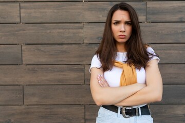 Photo of touchy sad upset offended resentful young brunet woman wearing casual white t-shirt and...