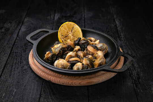 grilled seafood in a dark pan

