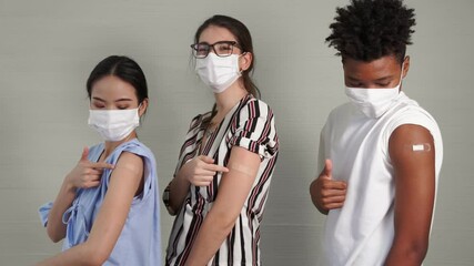 Diverse group of people showing COVID-19 vaccine bandage merrily in concept of coronavirus vaccination program to vaccinate citizen . - Powered by Adobe