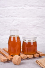Glass jar full of honey wooden honey dipper