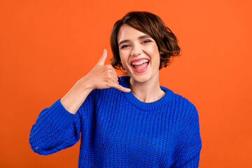 Photo of impressed brunette short hairdo young lady ask to call wear blue sweater isolated on...