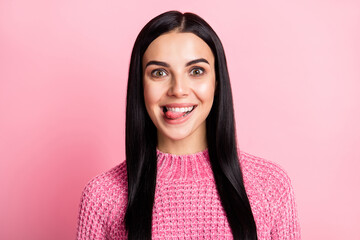 Fototapeta premium Portrait of adorable lady toothy smile teeth biting tongue out wear pullover isolated on pink color background