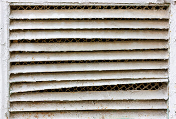 Old ventilation grill. Damaged ventilation duct grill.