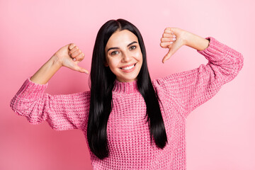 Photo portrait of woman pointing two thumbs at self isolated on pastel pink colored background