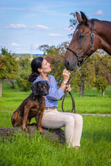 woman with horse and dog during a rest