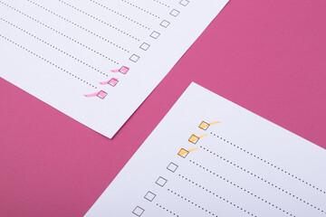 Check list with pink and orange marked points on pink background