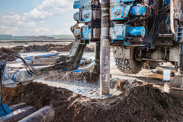 A drilling rig is working on a site. Deep hole drilling. Geological exploration work. Mineral...