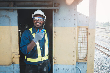 African engineer wears safety glasses, helmets and gloves to prevent accidents while working with...