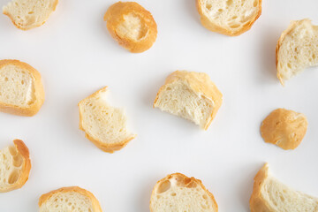 Slices of fresh bread pattern on a white background. Minimal creative food concept. Top view. Flat lay.