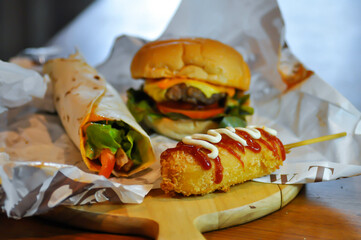 corn dog, pork sausage or breaded sausage with burger and kebab
