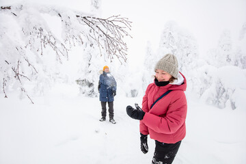 Family outdoors in winter forest