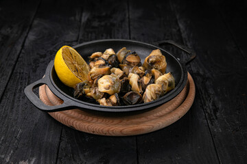 grilled seafood in a dark pan
