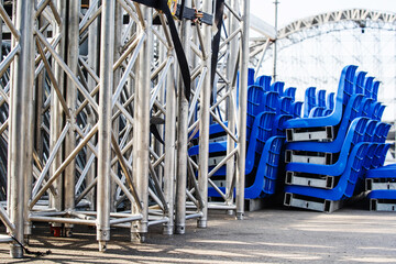 Mobile concert stage prepared for assembly and installation on the street. Metal structure with...