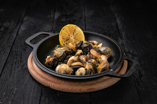 grilled seafood in a dark pan
