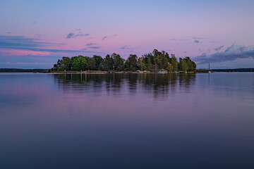 sunset over island in Baltic Sea bay
