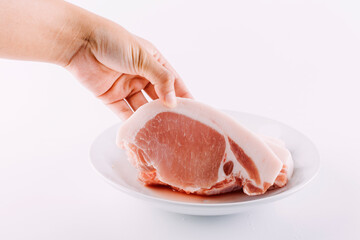 Raw picanha cut to be grilled viewed from above on a wooden board.