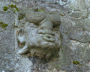 The head of a mythical character, carved out of stone, is located on the city wall in the city of Baden. Switzerland