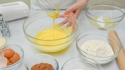 Whisk egg yolks with sugar in a glass bowl. Step by step chocolate cake recipe