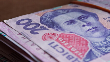 Portrait of Lesya Ukrainka in 200 hryvnia banknotes. Ukrainian paper bank notes, close-up.