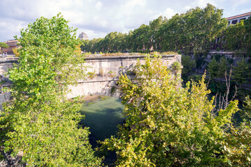 Fototapeta premium Along the banks of the Tiber River in Rome. Ancient bridges