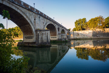 Fototapeta premium Along the banks of the Tiber River in Rome. Ancient bridges
