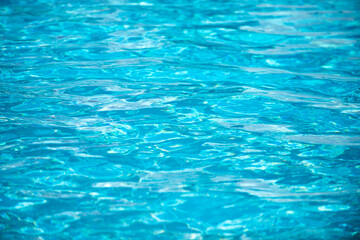 Abstract ripple wave and clear turquoise water surface in swimming pool, blue water wave for background and abstract design.