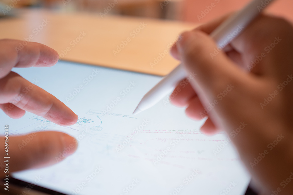 Fototapete plan and make notes by hand on a digital tablet, lists and flowcharts in the editor. the hand draws 