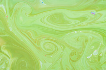Fototapeta na wymiar Green fluid art background. Liquid abstract pattern with UFO green. Marble texture of liquid surface. Fluid art