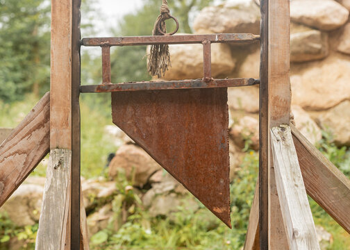 Guillotine, medieval decapitated equipment for punishment, blade closeup.