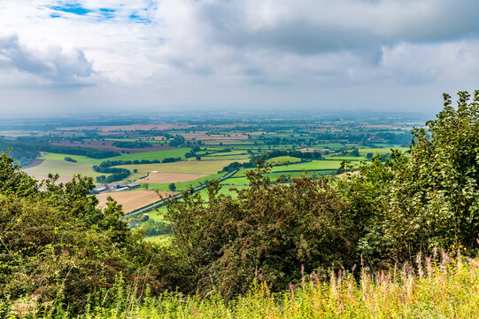 A view across hedgerows from Sutton Bank as storm clouds approach in Yorkshire, UK in summertime