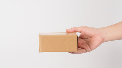 Hand is holding brown box isolated on white background.