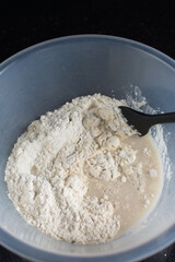 Partially mixed bread dough, flour being folded into water