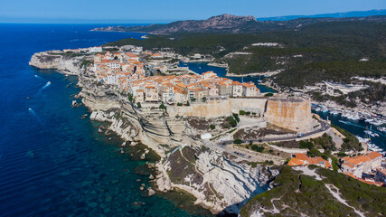 Aerial view of the medieval city of Bonifacio, built on a cape in the south of the island of Corsica in France - Old houses and citadel perched on a limestone promontory