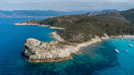 Aerial view of the Cavallata Tip in the Agriates Desert northwest of Saint Florent near the Cap Corse, Corsica, France - Leisure boats moored by the Small Lotu Beach