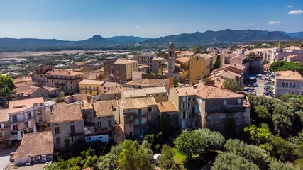 Fotobehang Aerial view of the citadel of Porto-Vecchio in the South of Corsica, France - Walled city center built by the Genoese in front of the Mediterranean Sea © Alexandre ROSA