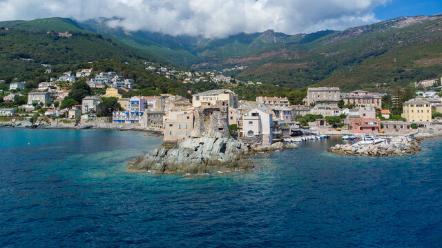 Aerial view of Erbalunga, a small fishing village on the Corsican Cape, France - Ruins of a Genoese Tower at the tip of a rocky cape in the Mediterranean Sea