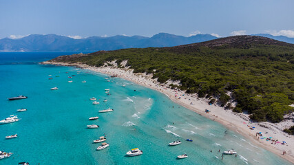 Aerial view of Saleccia Beach in the Agriates desert in Upper Corsica, France - Paradise beach in the Mediterranean Sea with tropical waters, only accessible by boat