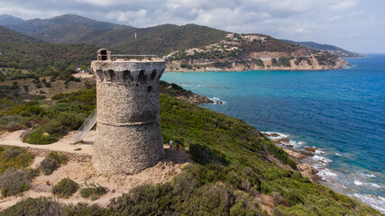 Fototapeta na wymiar Aerial view of the ruins of the round Genoese tower of Fautéa in the South of Corsica, France - Remains of a medieval lookout overlooking the Mediterranean Sea