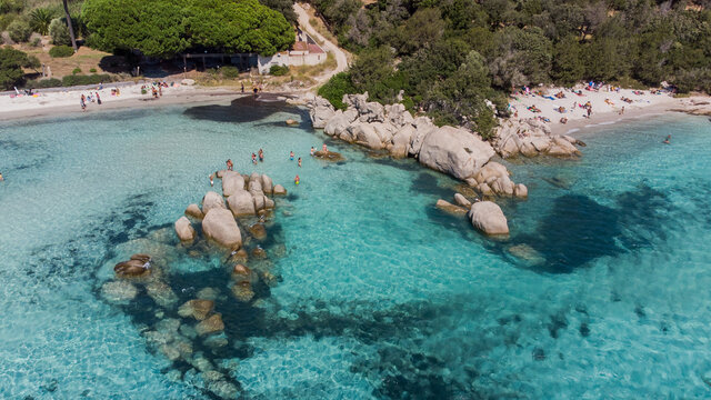 Aerial view of some sea rocks in the bay of Santa Giulia in the South of Corsica, France - Beach with shallow turquoise waters near Porto Vecchio in the Mediterranean Sea