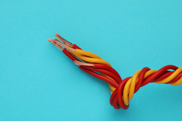 Obraz na płótnie Canvas Electrical wires on light blue background, closeup